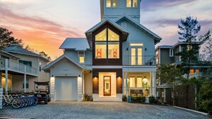 A two-story house with a garage, a covered porch, and a driveway. - Gulf Views, LSV, Pool and 2 Blocks to Beach (Santa Rosa Beach)