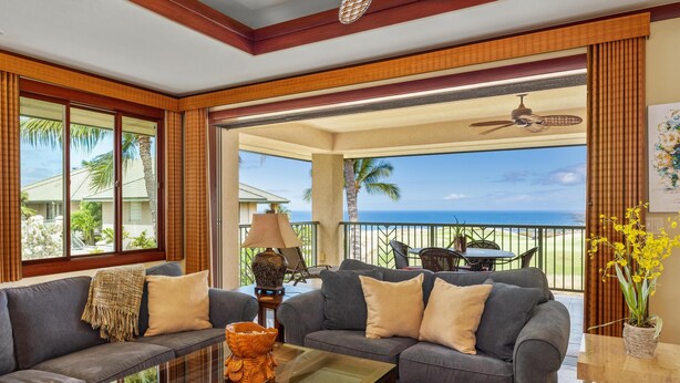 A spacious living area with a sofa set, a coffee table, and a view of the ocean. - Summer Deal Luxury Mauna Kea 3BR Condo with Ocean and Golf Views (Kamuela)