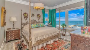 A four-poster bed with a view of the ocean, a large window with curtains, and a decorative mirror. - Luxury Home with Private Pool and Stunning Views (Garden City Beach)