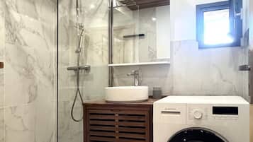 Bathtub, hair dryer, soap, toilet paper