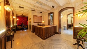 A luxurious lobby with a marble floor, a central wooden reception desk, and elegant lighting fixtures. - Meroddi Barnathan Hotel (Istanbul)