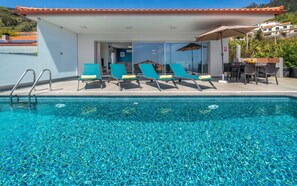 An infinity pool, a heated pool, pool loungers