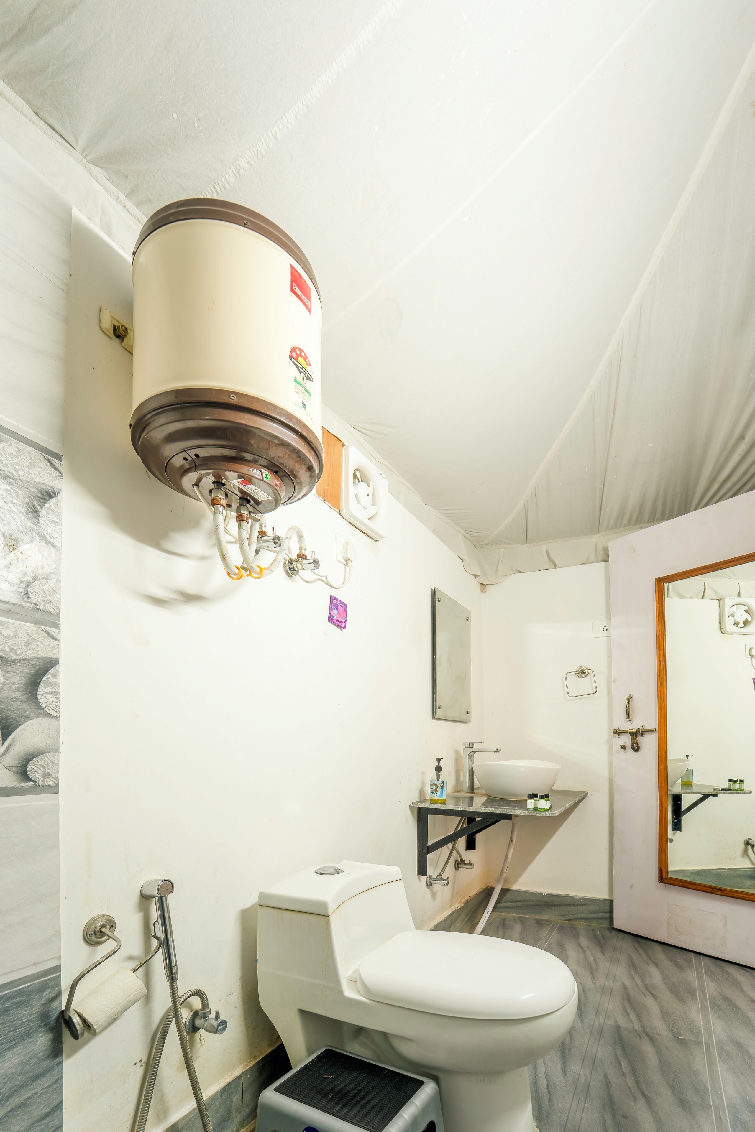Une salle de bain avec des toilettes, un lavabo et une douche.