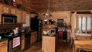 A cozy kitchen with wooden walls, a stainless steel stove, a microwave, and a coffee station. - ⭐️Glory Days Cottage⭐️ Cozy/Quiet/Serene🏡 (Mentone)