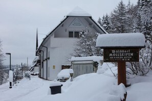 A snow-covered building with a sign indicating 'Pension Walddorf'. - pension walddorf (Winterberg)