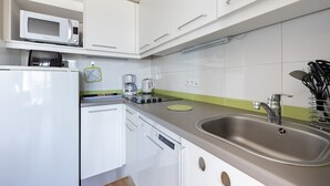 A modern kitchen with white cabinets, a stainless steel sink, a microwave, and a coffee maker. - Courlis Cendré - Two Bedroom House, Sleeps 7 (Courseulles-sur-Mer)