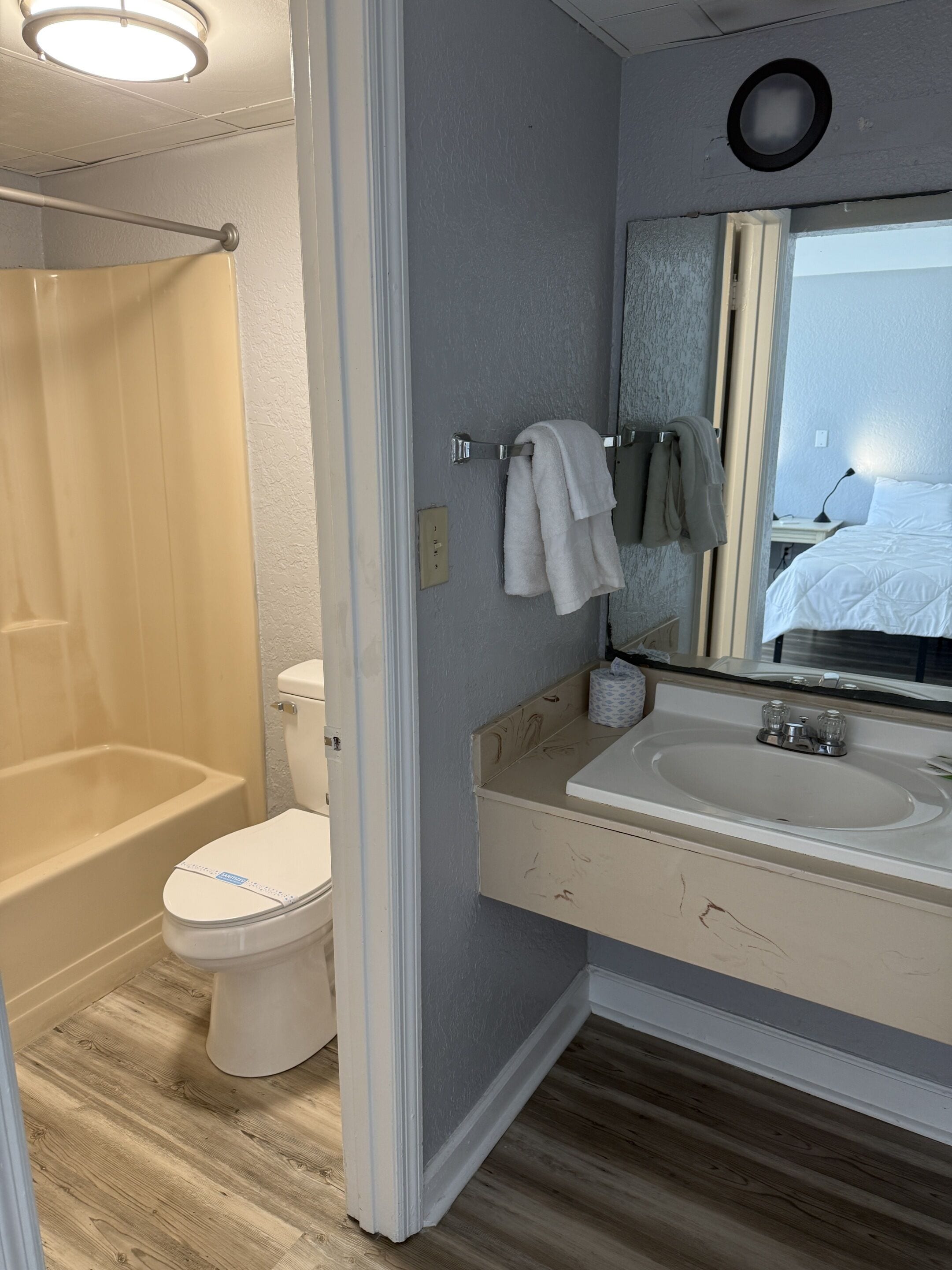 A modern bathroom with a bathtub, toilet, and sink.