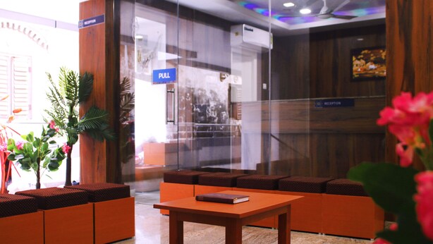 A reception area with a reception desk, seating area, and a 'PULL' sign.