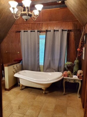 Bathtub, towels, soap, toilet paper