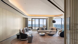 A modern living room with a large window, a sofa set, and a coffee table. - Qinhuangdao Marriott Resort (Qinhuangdao)