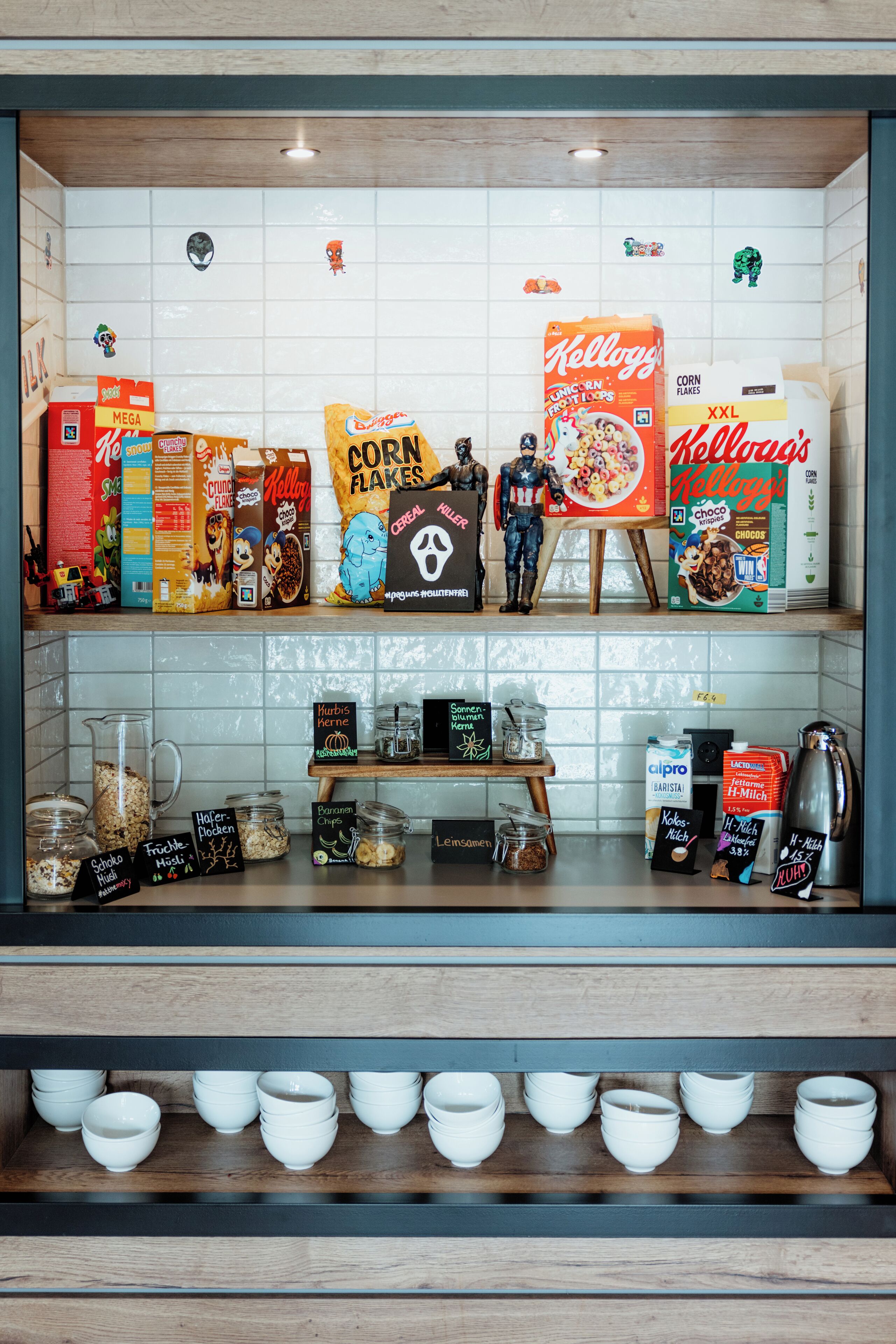 A kitchen counter with cereal boxes, snacks, and kitchenware.
