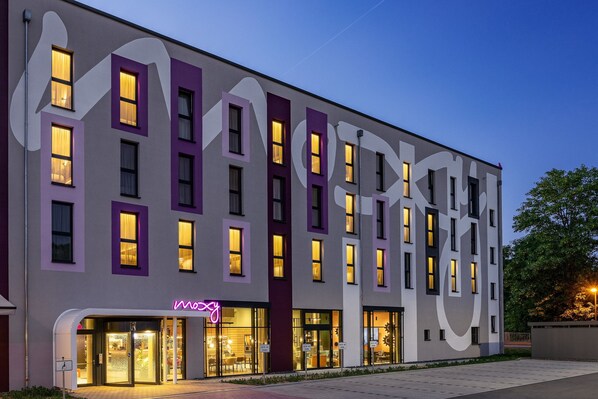 A modern hotel with a unique facade featuring large geometric patterns and purple accents.