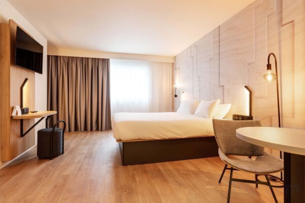 Premium bedding, desk, laptop workspace, blackout drapes