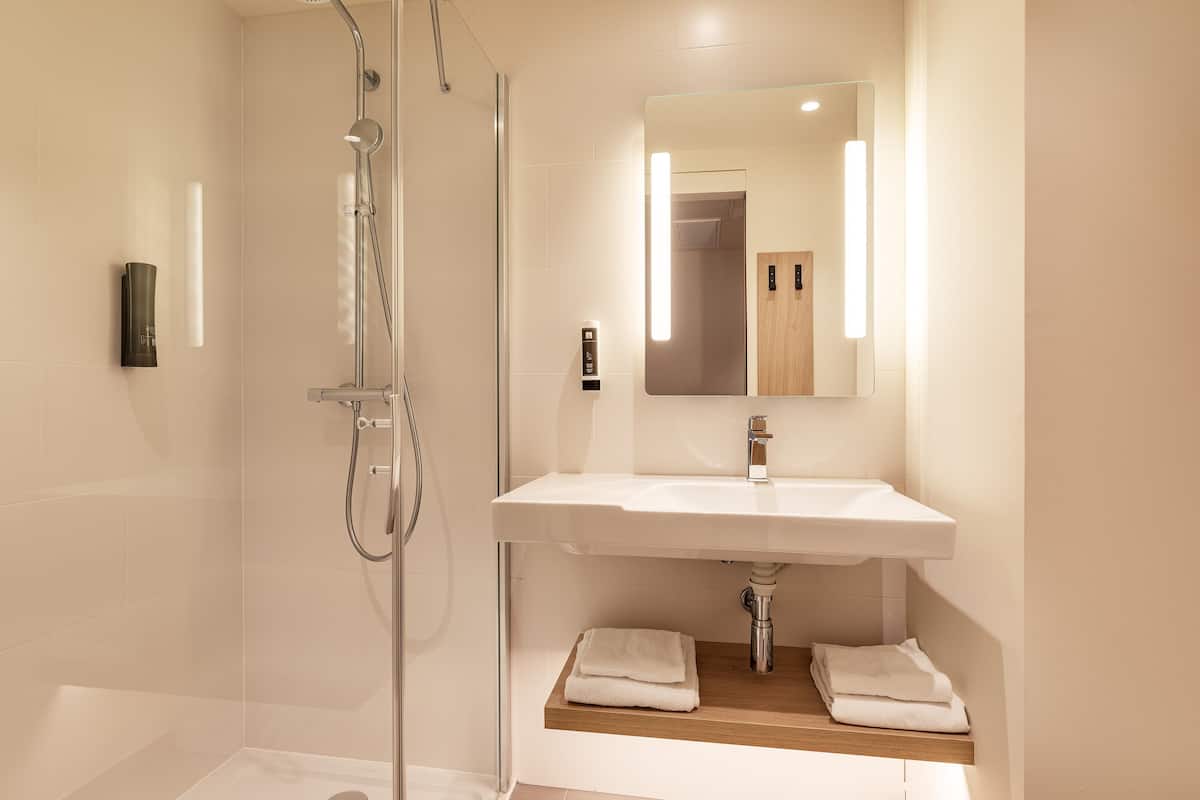 shower, rainfall showerhead, hair dryer, towels