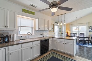Enjoy meals in this well-equipped kitchen with a granite countertop, kitchen island, and dining area.