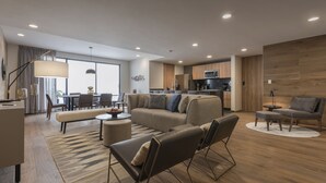 A modern living room with a sofa, chairs, a coffee table, and a dining area with a table and chairs. - Leonora Boutique Stays by Viadora (Mexico City)
