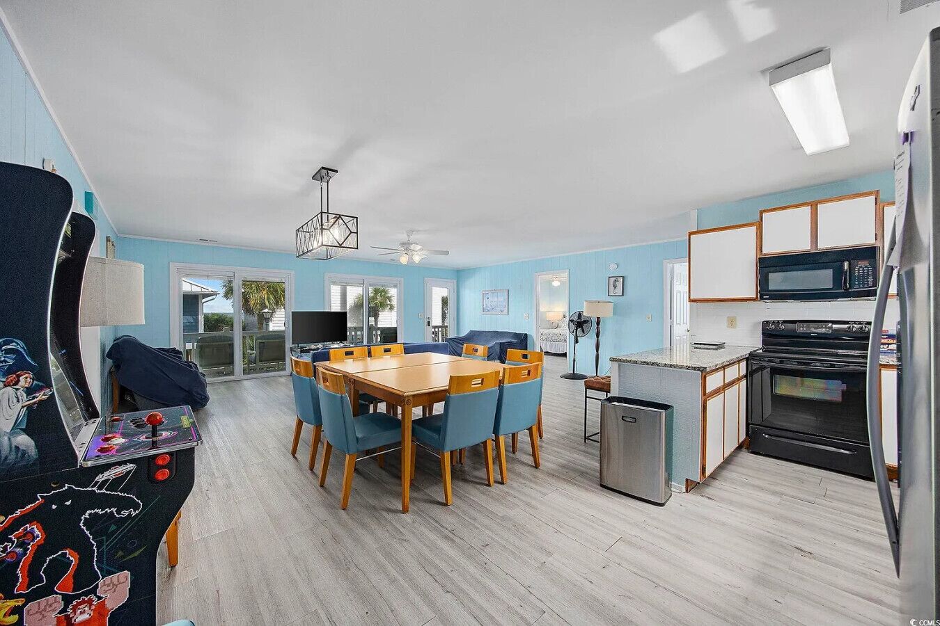A modern kitchen with a microwave, oven, and refrigerator.