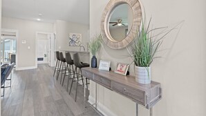 A modern kitchen with a wooden countertop, a round mirror, and a 'No Smoking' sign.