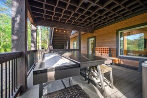 Enjoy meals under a shaded pergola with a long dining table and comfortable seating for multiple guests.