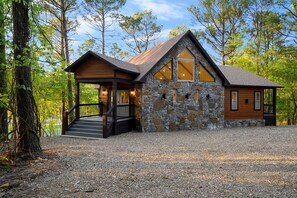 Enter a serene environment surrounded by nature, with a sheltered entrance to the main building.