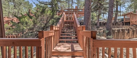 Stroll up the staircase to a charming retreat surrounded by tall pine trees.