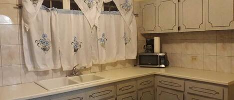 Fridge, microwave, stovetop, coffee/tea maker