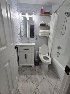 Combined shower/tub, hair dryer, towels, soap