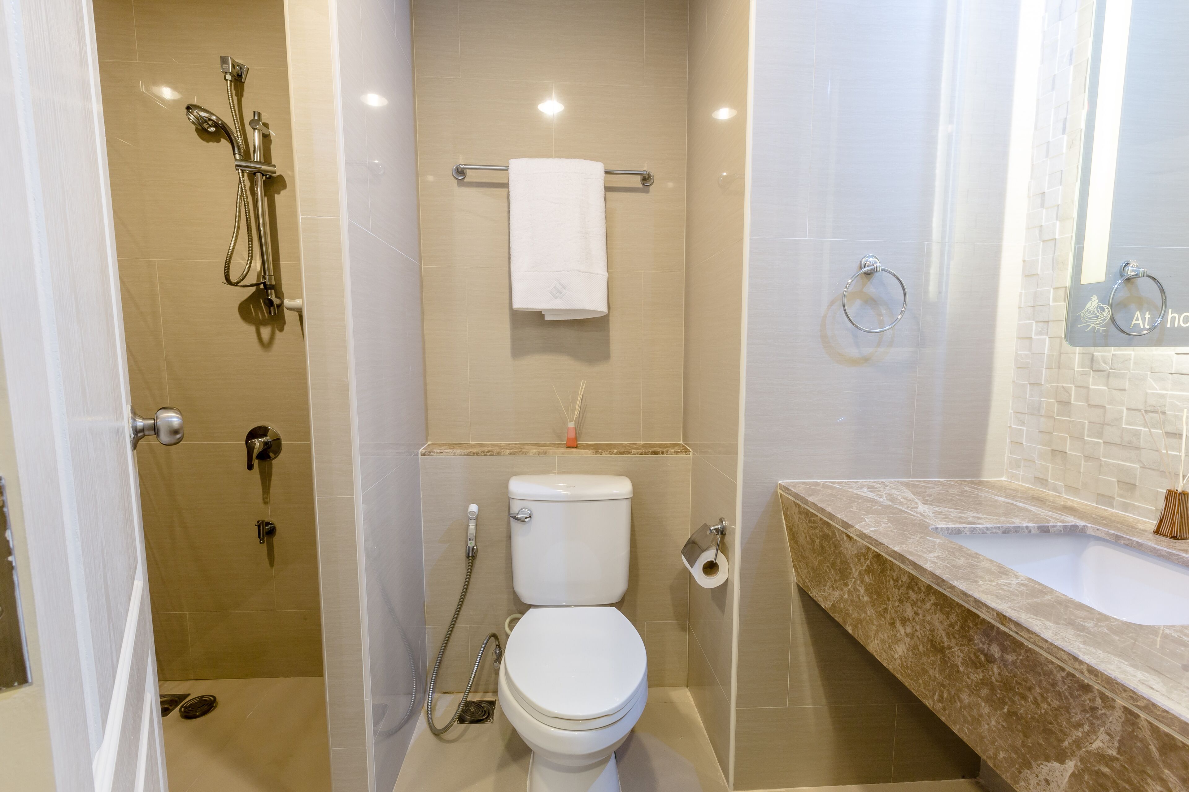 A bathroom with a shower, toilet, and sink.