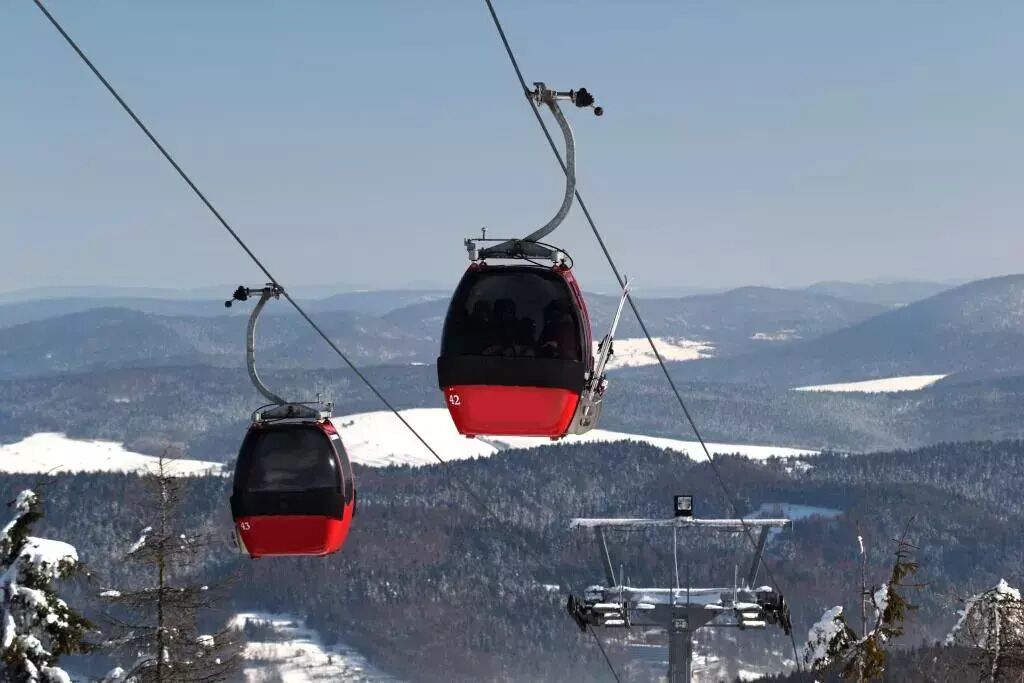 A cable car system with a clear view of the surrounding mountainous landscape.