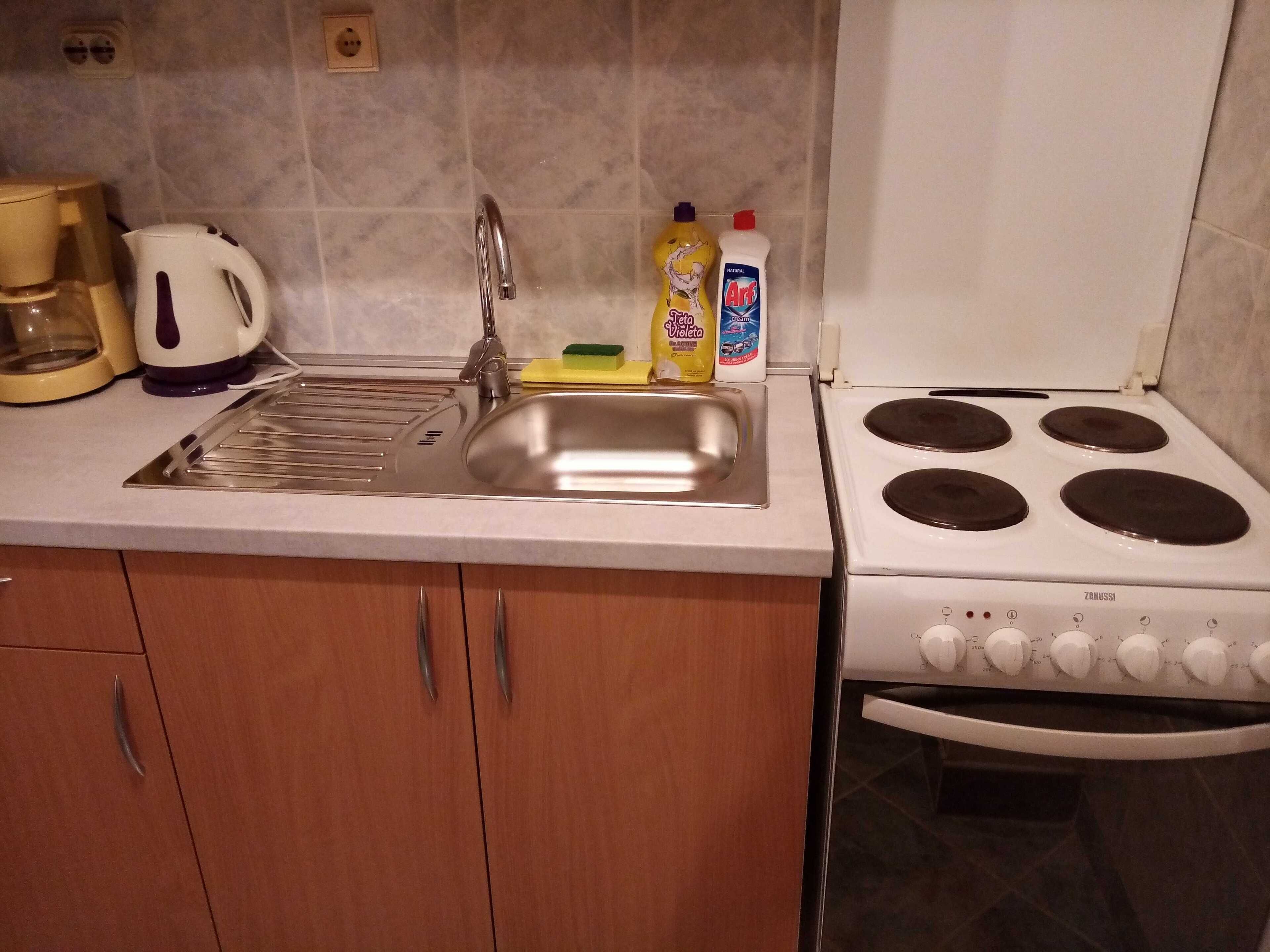 A kitchen with a sink, stove, and various appliances.