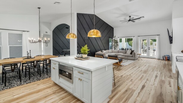 A modern kitchen with a central island, pendant lights, and a ceiling fan. - Black Palm! Sparkling Pool, Pool Table, Close To Kierland Entertainment, Newly Designed Beauty! (Scottsdale)