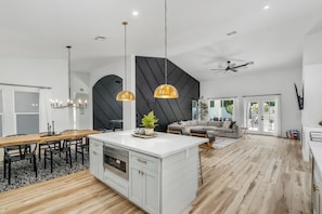 A modern kitchen with a central island, pendant lights, and a ceiling fan. - Black Palm! Sparkling Pool, Pool Table, Close To Kierland Entertainment, Newly Designed Beauty! (Scottsdale)