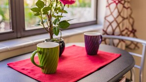 A table with a red cloth, a green mug, and a purple mug. - 🏳️‍🌈 #1 Walk to Wilton Drive (fort lauderdale)