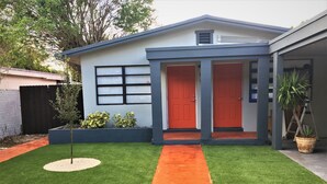 A modern house with a red door, a blue exterior, and a well-maintained lawn. - 🏳️‍🌈 #1 Walk to Wilton Drive (fort lauderdale)