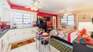 A compact kitchen with white cabinets, a black refrigerator, and a dining area with a small table and chairs. - 🏳️‍🌈 #2:  Walk to Wilton Drive (with kitchen) (fort lauderdale)