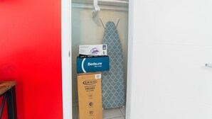 A closet with a hanging iron, a blue iron box, and a Graco pack 'n play portable playard. - 🏳️‍🌈 #2:  Walk to Wilton Drive (with kitchen) (fort lauderdale)