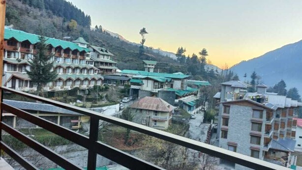 A mountainous village with traditional buildings and a wooden balcony. - Hotel Ireland (Manali)