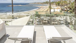 A rooftop terrace with a clear view of the beach, palm trees, and a pool area. - B51 Executive Flats Marbella Puerto Banus (Marbella)
