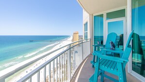 A balcony with turquoise chairs overlooking a beach and ocean. - 1BR 2BA @ THE AQUA SLEEPS 6!! (Panama City Beach)