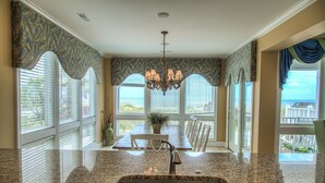 A kitchen with a granite countertop, stainless steel sink, and a chandelier. - 7 Bed, 7.5 Bath, Oceanfront Home, Private Pool that can be heated (Garden City Beach)
