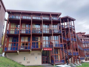 A multi-story hotel with balconies and a sign reading "Aiguille Grive II".
