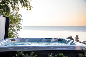 A hot tub with a view of the sea.