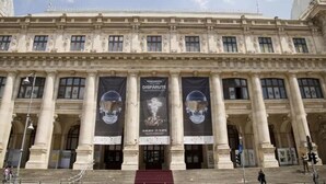 A large, classical building with columns and banners. - Apartment Central Gardens (București)