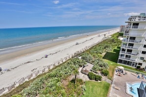 A beachfront hotel with a pool, beach access, and a view of the ocean. - 5301 Shorehom By The Sea 73 2 Bedroom Condo by RedAwning (New Smyrna Beach)
