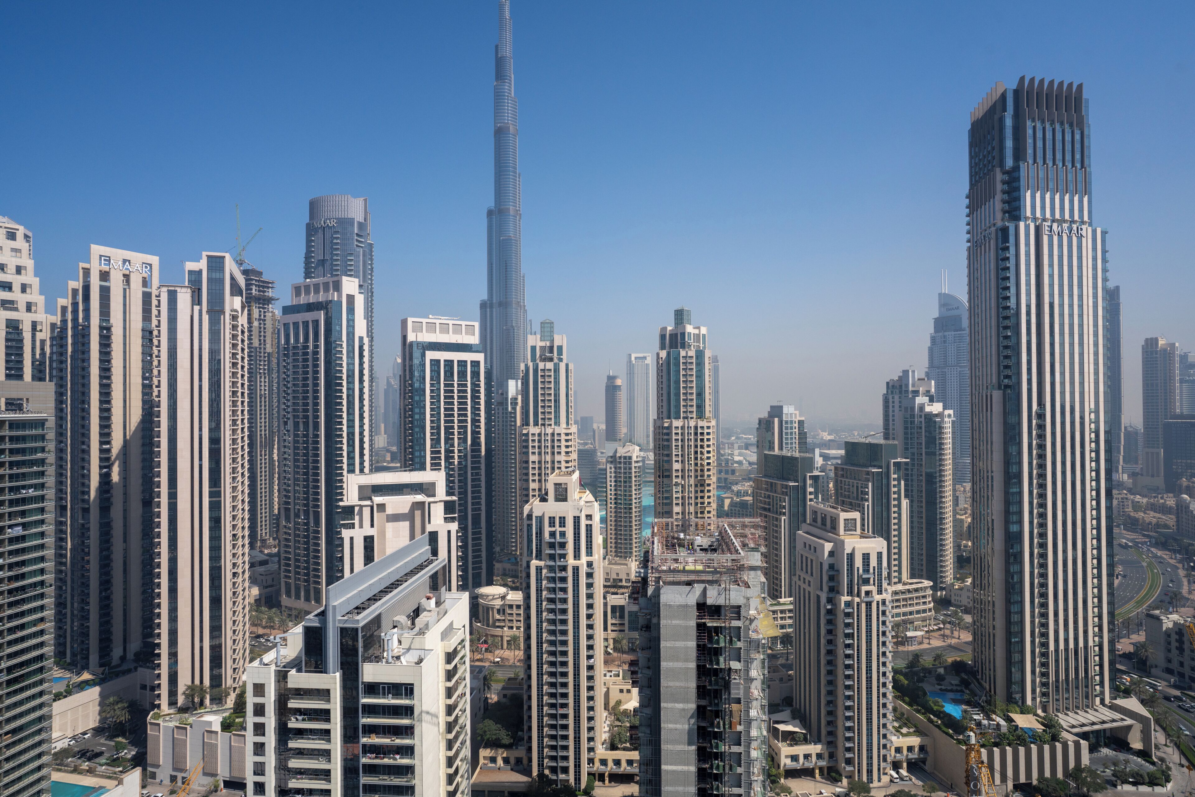 A high-rise urban skyline with multiple buildings, including a prominent tower.