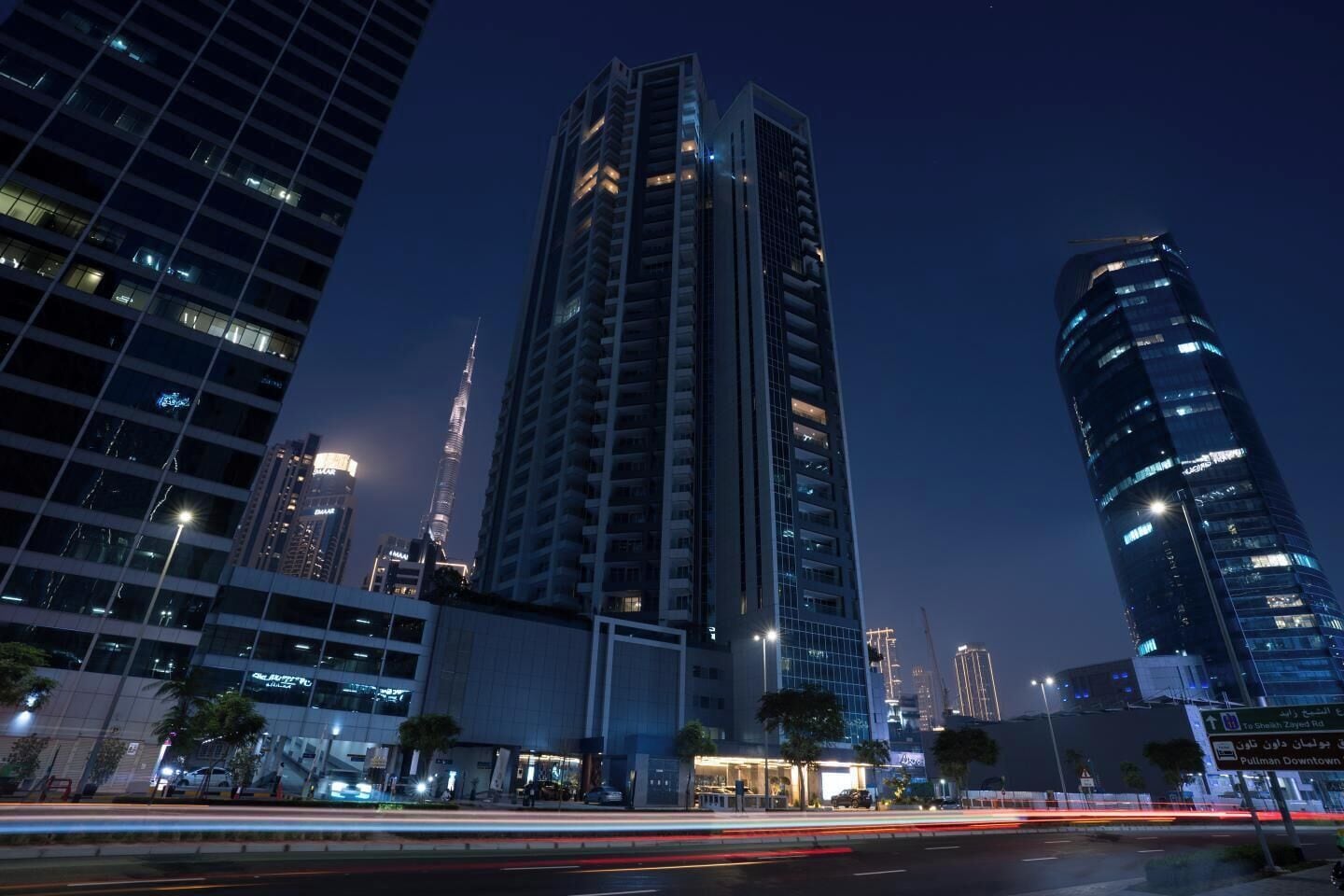 A high-rise building with a modern design, surrounded by other tall structures.