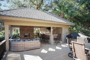 An outdoor patio with a covered seating area, a barbecue station, and a stone fireplace. - 3 Sprunt Pond at The Sea Pines Resort (Hilton Head Island)