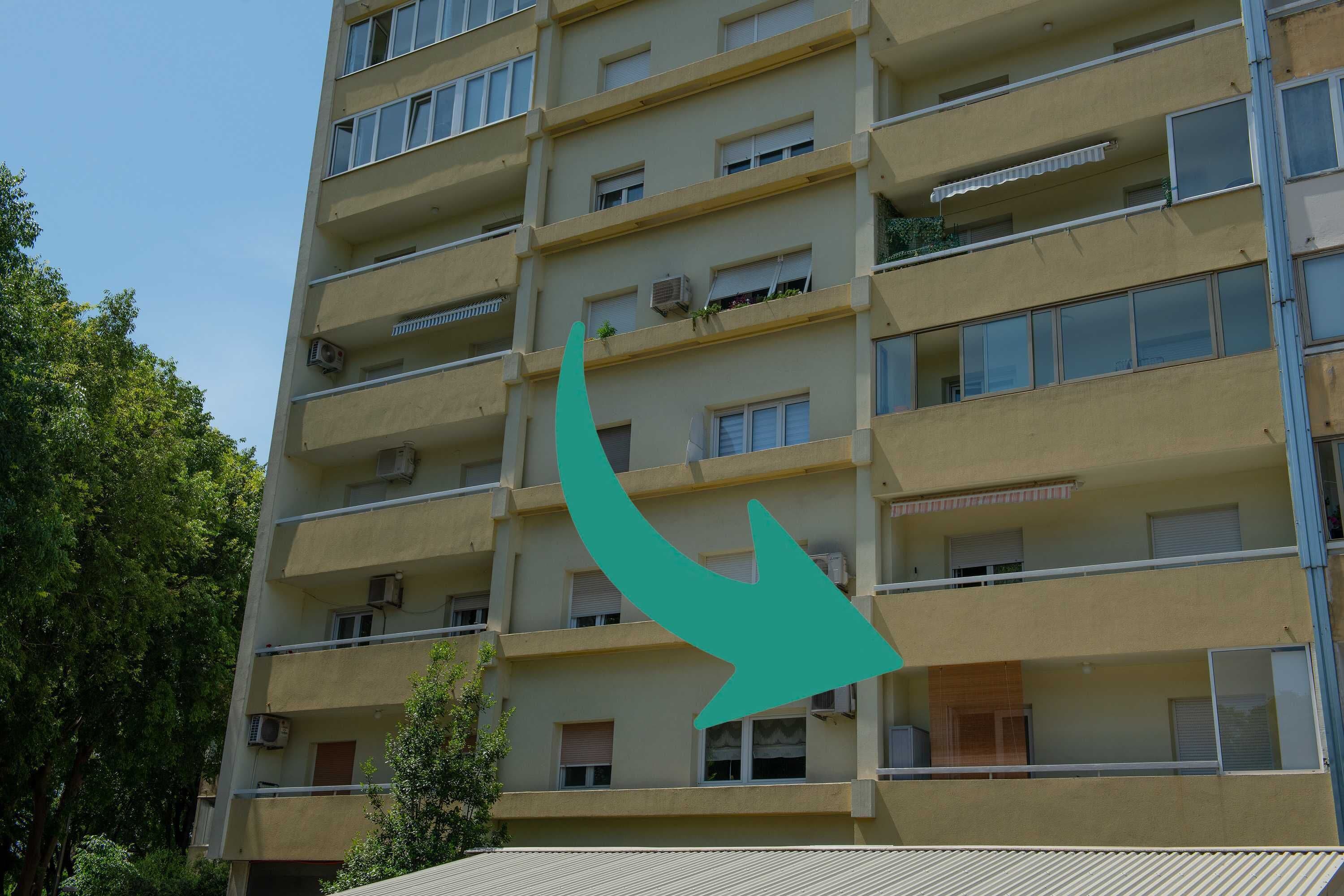 A multi-story building with balconies and windows.