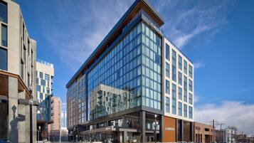 A modern hotel with a glass facade, multiple floors, and a prominent 'Meridian' sign.