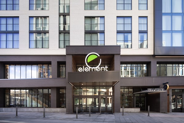 A modern building with a prominent 'element' logo and a 'VAN RYDER' sign.